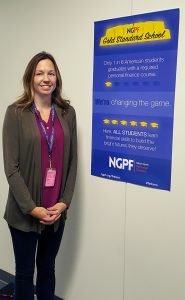 JHS teacher Kayla Bousum stands next to the NGPF poster